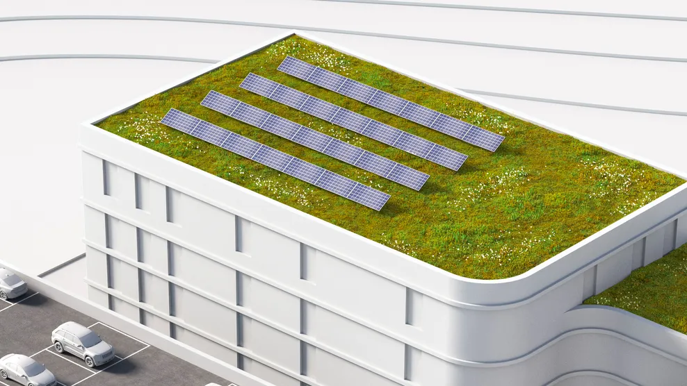 En arkitektmodell av en bygning med sedum og solceller på taket
